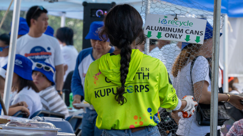 A G3CC member collects aluminum from celebrants at the 81st Liberation Day Parade.