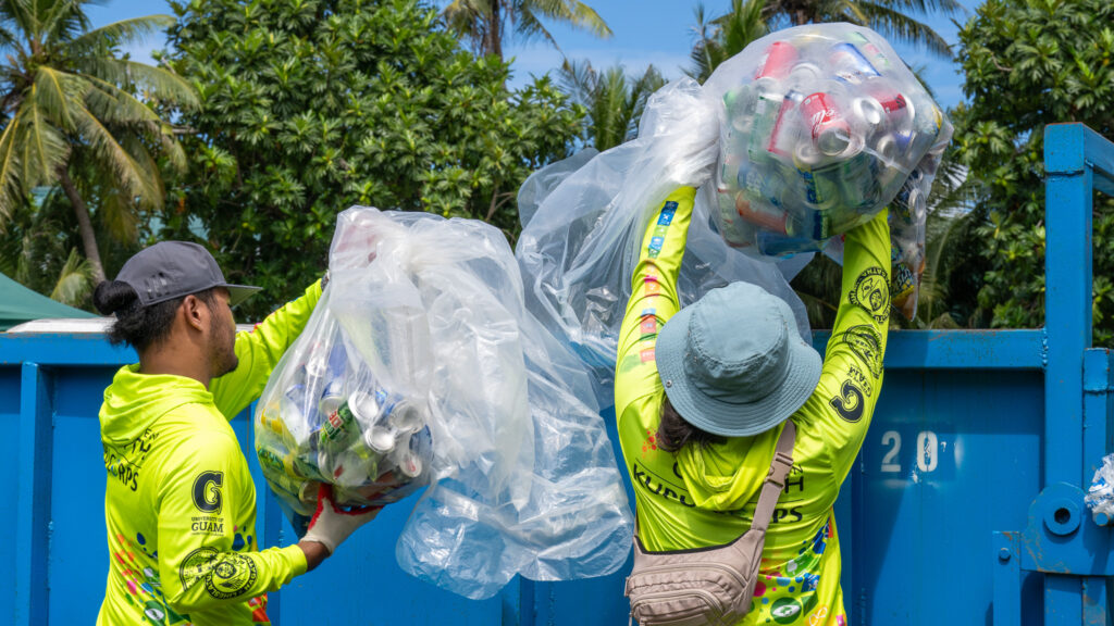 G3CC members consolidating cans collected on the parade route to a large bin.