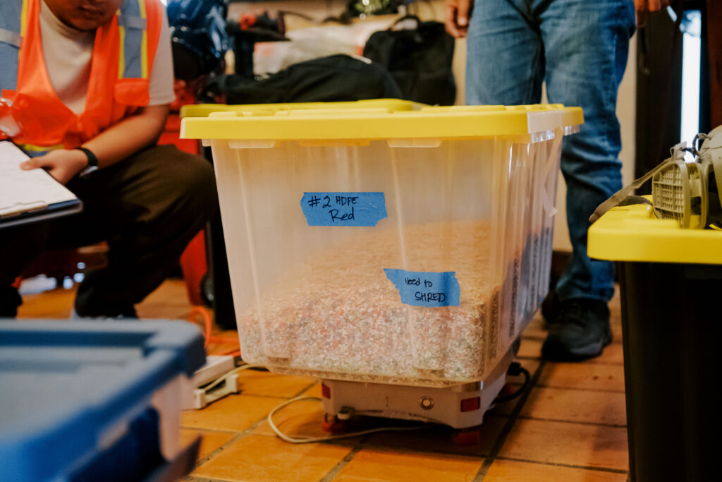 The research project involves using the shredder and extruder machines at the Guam Green Growth (G3) Circular Economy Makerspace & Innovation Hub to prototype commercial-grade plastic lumber from recyclable plastic, shredded into small components like the one shown above.