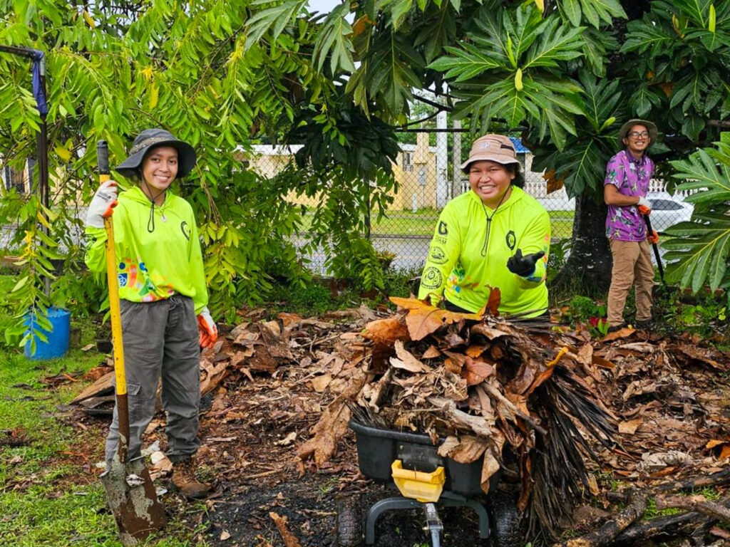Eyana Pereda and Mi’Yah Max remove foliage from the community garden at Island Girl Power.
