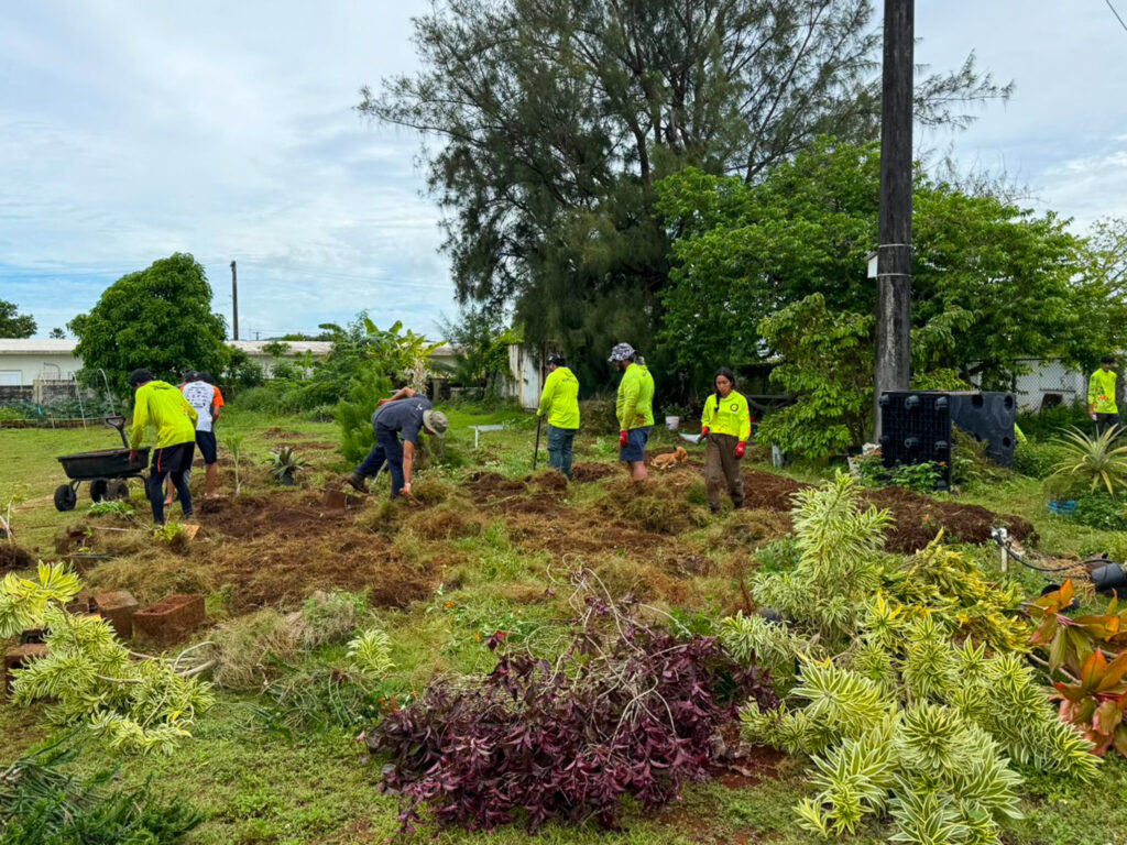 The G3CC in process of sprucing up the Island Girl Power community gardens.