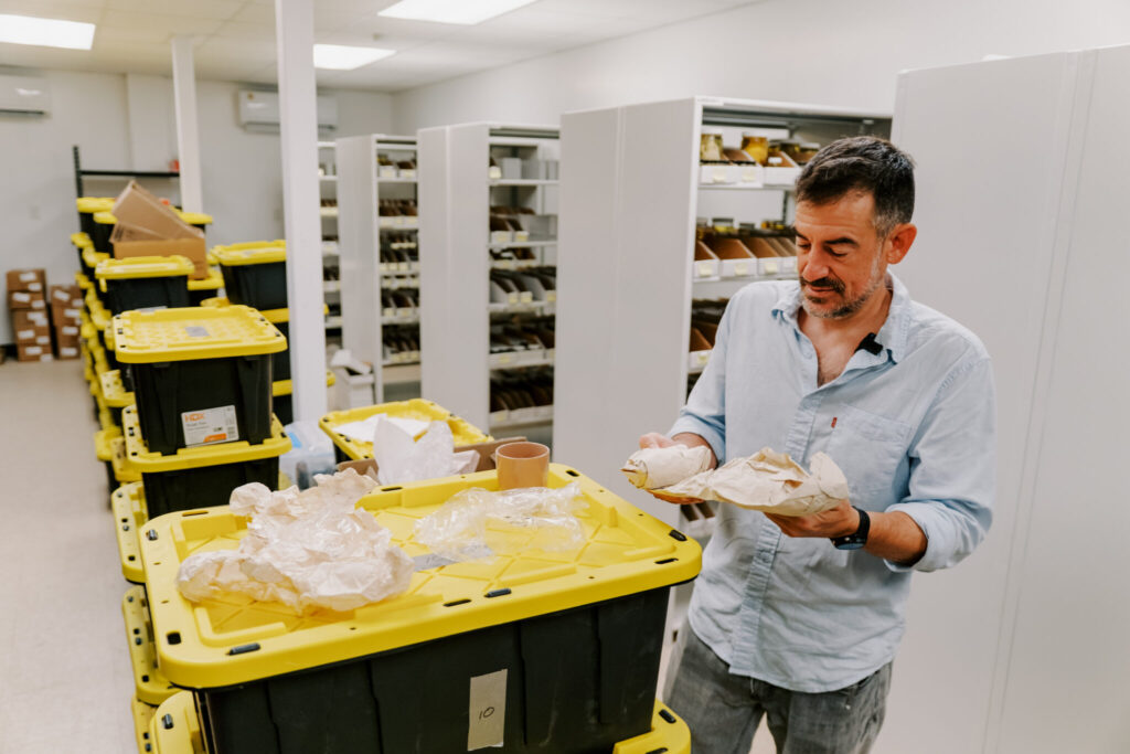 Robert Lasley, Ph.D., assistant professor and curator of crustacea at the UOG Biorepository, examines shell samples donated by collector Warren Carah. The collection features shells collected by Carah on Guam during his time on Guam in the early 1960s.