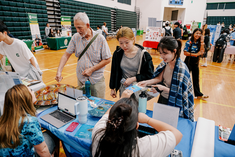 Ella Fedenko from the UOG CIS and Sea Grant turtle project and Franki Guerrero from Guam NSF EPSCoR provide incoming students with information on their projects and potential fellowship opportunities.  The two programs were among the many represented by the group.