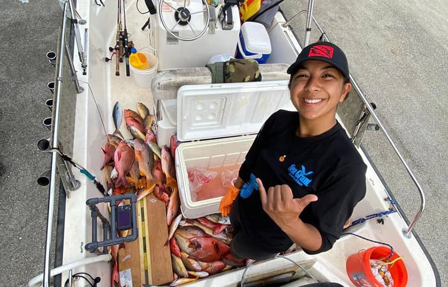 Leilani Sablan Naden, program lead for Guihan for Guåhan , posing inside a fishing boat